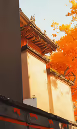 an asian building with orange leaves surrounding it