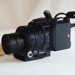 an old movie camera with black shutters