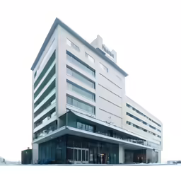 an open building that is next to some tall buildings