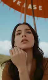 a close up of a person holding a red umbrella