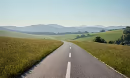 a rural country road in a grassy, grassy area