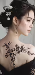 woman wearing flowers tattoo with black dress