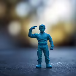 a toy man pointing towards something on the ground