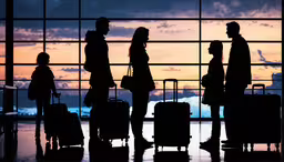 people waiting for the airplane at an airport,several people with their luggage at the airport