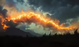 a view from a hill of the clouds over a mountain