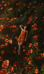 woman laying in a field of orange flowers