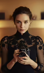 a woman holding an analog camera taking a picture