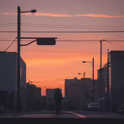 silhouette of a man walking along a city street