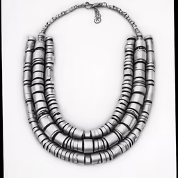 the silver necklace is decorated with metal beads
