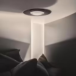 an empty room with a round light fixture
