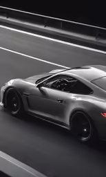 the grey sports car driving down a city street