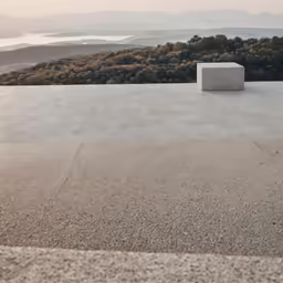 a small object on top of a building near some mountains