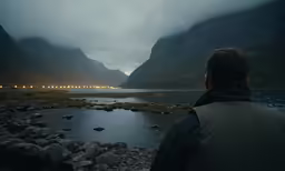 a man that is standing near a lake