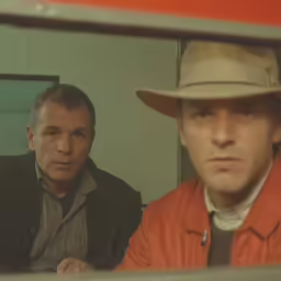 two men are posing for a photo in front of a mirror