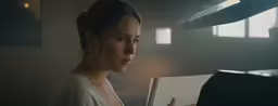 woman in white top reading book near ceiling