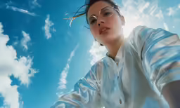 woman standing in front of a sunny blue sky