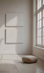 a large white room with a window and a chair