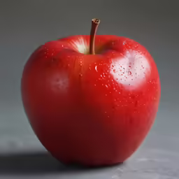 an apple with water drops is placed on the surface