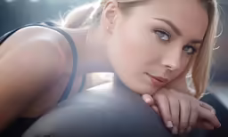 a blond woman is leaning her hand on the side