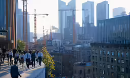 a group of people walk down the side of a bridge
