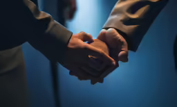 the hands of two people holding each other