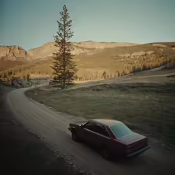 a car on the side of a dirt road