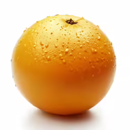 the orange is half covered with water drops