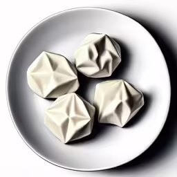 a plate that has three small white ballons on it
