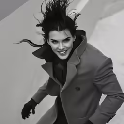 a woman in black and white is smiling