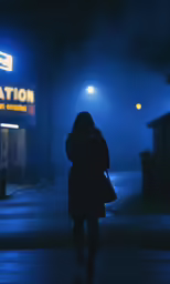 a woman walking down the street on a cold night