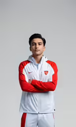 a man in white and red jacket posing for the camera
