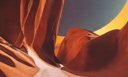 a photo with the sun going down, looking up in an oddly shaped rock formation