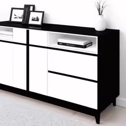 white and black sideboard with a picture hanging on it