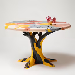a table sitting on the ground with an artistic surface