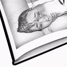 an open book has drawings of a person on it