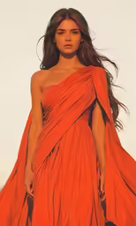 an orange dress on a runway in front of a camera