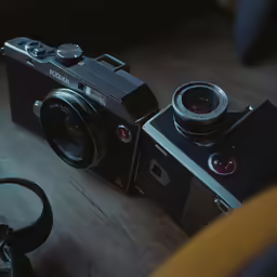 an old camera on a wooden table with headphones