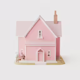 a toy pink house with white trim and red doors