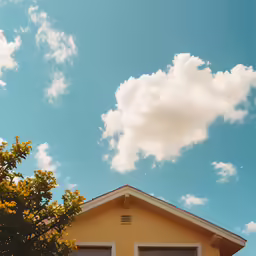 the sky is clear and very cloudy with the building in the foreground