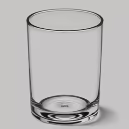 a glass cup sitting on a table next to a light