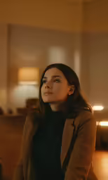 a woman in black shirt sitting in a room