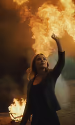 the woman is holding her arms up in the air
