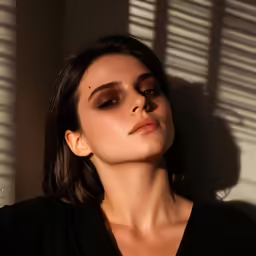 the model is posing for a photo while holding her arm out and looking straight ahead