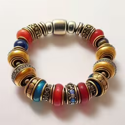 a close up of a bracelet with many different color beads,a bracelet made out of various pieces of jewelry