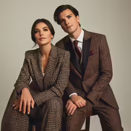 two people sitting in chairs next to each other