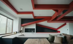 this is an open concept living room with black walls and red accents