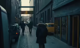 a lady walking down the street in an alley in the winter
