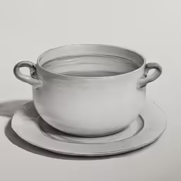 a silver cup on a plate with a saucer