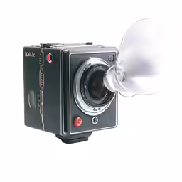 the large black camera has white flash light attached to it