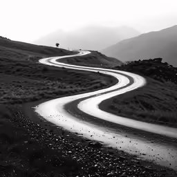 black and white photograph of a long winding road